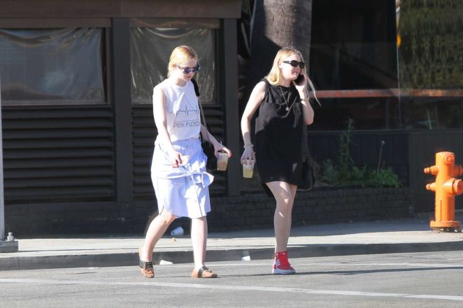 Dakota and Elle Fanning - Checking out of a hotel together in LA